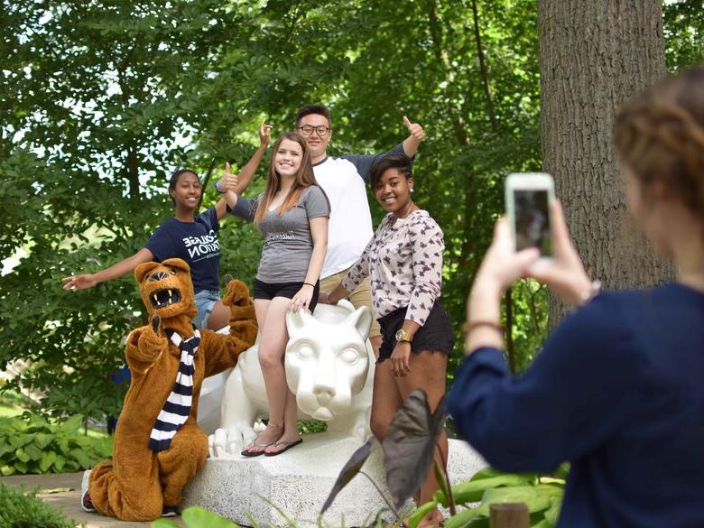 Students pose for a photo by the Lion Shrine at Penn State Abington (near Philadelphia)